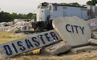 Rocks labeled "Disaster City" in front of a staged train wreck. 