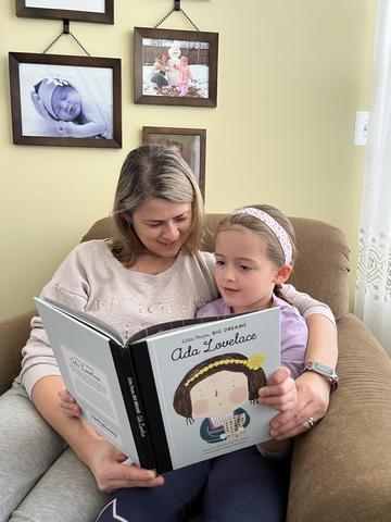 NIST researcher Justyna Zwolak reads a book about Ada Lovelace to her young daughter