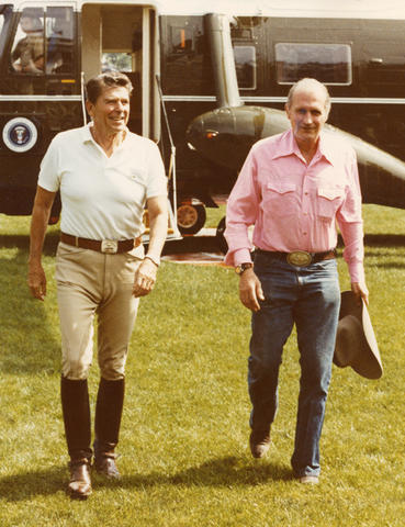 President Ronald Reagan and Secretary Baldrige walking away from a helicopter.
