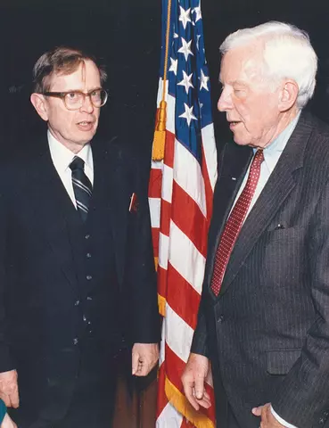 Reimann and Verity standing together by the U.S. flag.