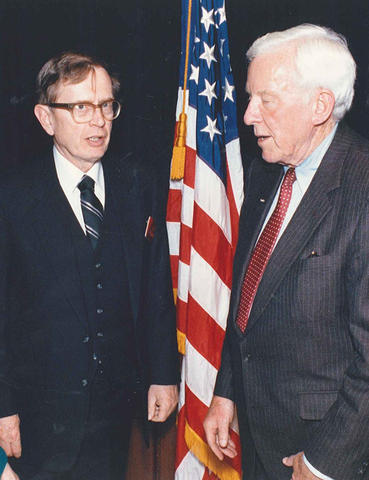 Reimann and Verity standing together by the U.S. flag.