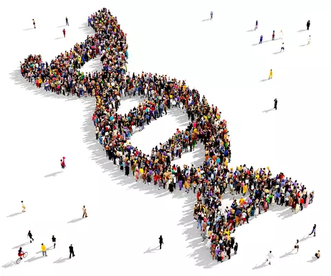 A large group of people stand in the shape of a DNA double helix