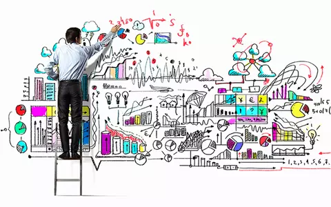 Operations image showing a business man standing on a ladder writing on the wall.