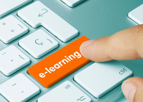 Finger tapping orange key on keyboard e-learning