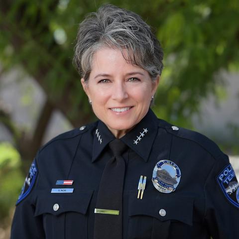 Headshot of a smiling woman in a police uniform