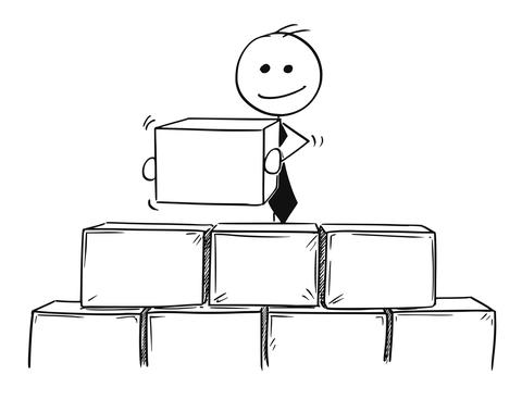Stick figure o a person with a tie stacking large blocks