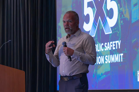 NIST PSCR Division Chief Dereck Orr speaks on stage during 5x5.