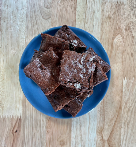 Baked brownies on a blue place on a wood surface