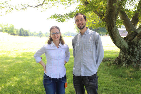 Zachary Vaz and Susana Teixeira  in grassy area by tree