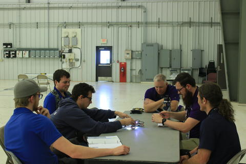 Team Uniform Sierra members displaying UAS at table of judges