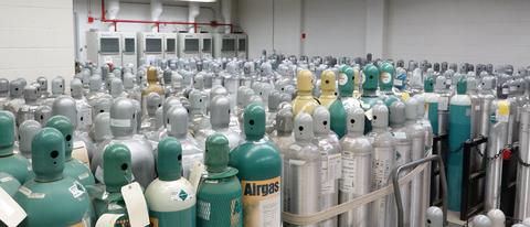 Photograph of hundreds of gas cylinders in a gas storage facility.