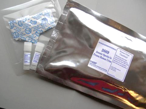 Photograph of SRM 2669 Arsenic Species in Frozen Human Urine, with vials and desiccant packs, and labeled mylar bag.