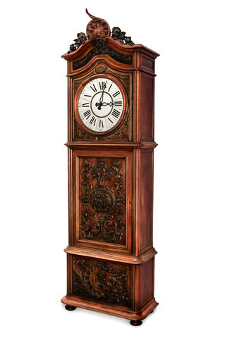 An ornate antique grandfather clock with roman numerals on its face