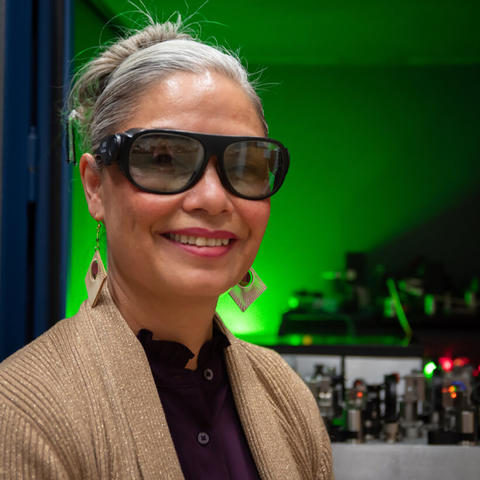 Tara Fortier wears safety glasses as she poses in the lab for a portrait.