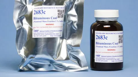 Photograph of a labeled mylar envelop and labeled amber bottle containing SRM 2683c Bituminous Coal. 