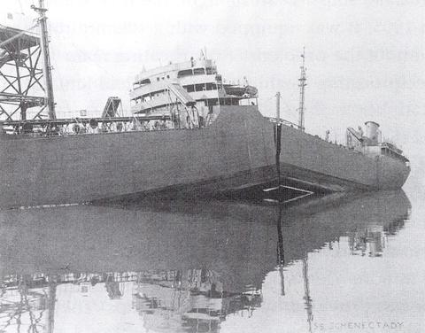 Historical newspaper photo shows a large ship in port with a crack down the center, splitting it almost in half. 