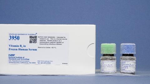 Photograph of SRM 3950 Vitamin B6 in Frozen Human Serum with labeled box and frosty capped bottles containing level 1 and level 2. 