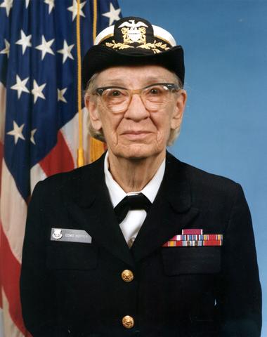 Grace Hopper poses in uniform for an official military headshot.
