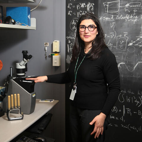 Elham Tabassi demonstrates a fingerprint scanner in her office at NIST.