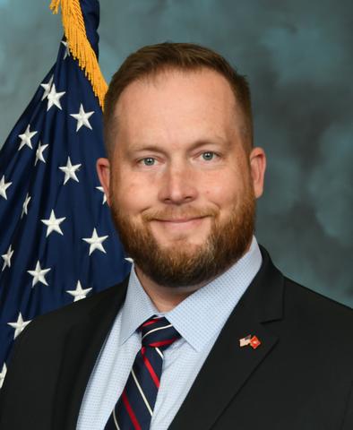 Professional Photo, Black Suit, in front of American Flag