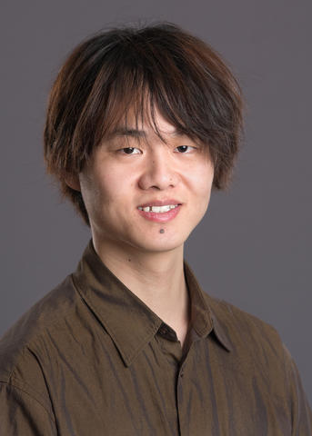 Jialei Shen, brown shirt, brown hair, gray background