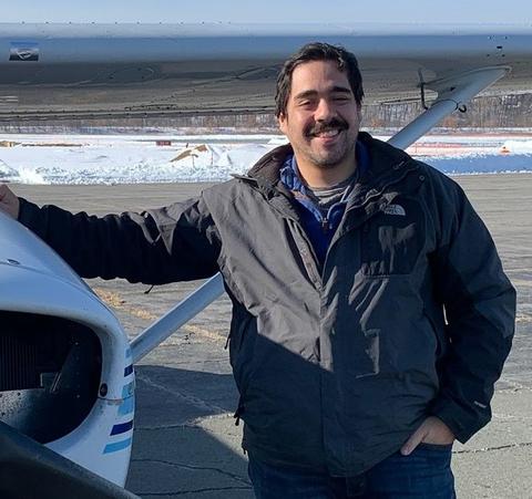 Giovanni Di Cristina standing in front of plane. 