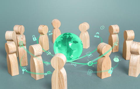 People situated around a globe having a discussion