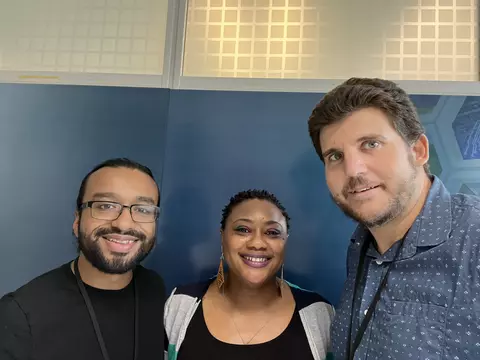 three smiling people