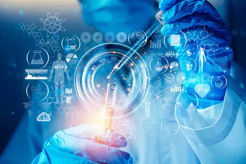 A laboratory technician wearing gloves, a mask and a lab coat holds a dropper over a vial with liquid that is held in the other hand. There are digital images floating around the center of the image as if seen on an invisible screen. The dropper is not exactly lined up with the opening of the vial, indicating that we are looking at the moment after the task of putting the liquid from the dropper into the vial is done and now the digital analysis will take place.