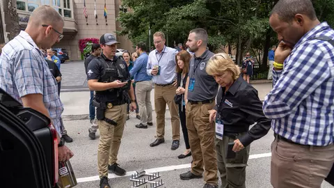 Attendees observing public safety demo from local police department outside the hotel at 5x5