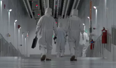 Photo of employees walking inside the fab facility in New York