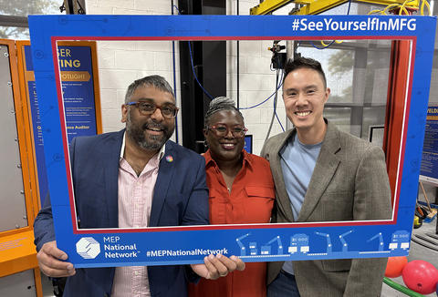 Three people standing in a selfie frame