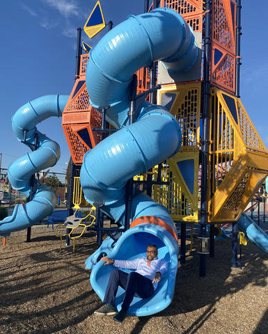 Man sliding down a winding slide