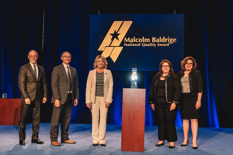 City of Henderson standing beside their 2024 Baldrige Award Crystal.