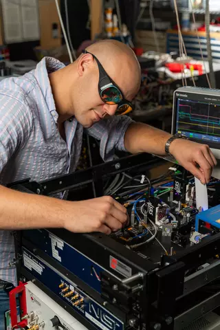 Man with safety glasses working on clock