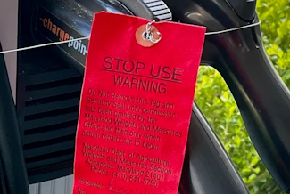 Photo of Red STOP USE Tag– WARNING Do Not Remove this Tag and Security Seal until permission has been granted by the Maryland Weights and Measures Office and then only when actual repairs are to begin. 