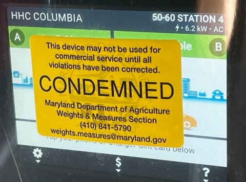  An EV charger in Columbia is covered by a “Condemned” sticker from the Maryland Department of Agriculture