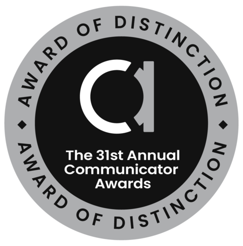 Round badge. Inner circle: fancy lowercase "A". Words: The 31st Annual Communicator Awards. Outer ring: Award of Distinction