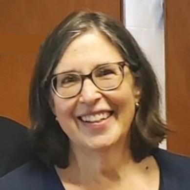 Smiling white woman with chin-length dark brown hair and glasses