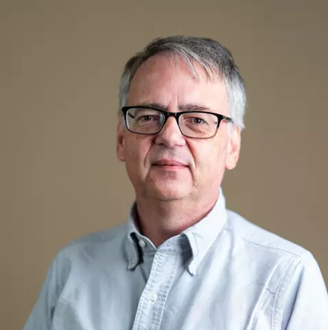 Photo of Andrew Reid, a middle-aged white man with a white shirt.