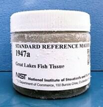 glass jar container with a white cap and white label that reads "Standard Reference Material 1947a great lakes fish tissue"