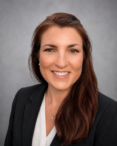 May 2026 professional headshot of Colleen Bryan with long brunette hair wearing a black blazer and white blouse