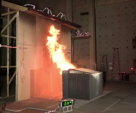 A steel closet shed at 1.5 m (5 ft) separation and containing 4 wood cribs burns and creates a fire plume contacting the target eaves.