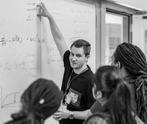 Sam instructing at a white board