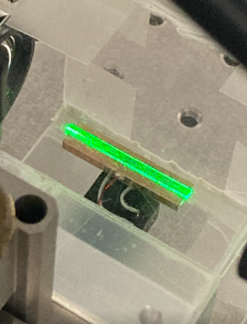 Waveguide squeezing crystal with green pump light