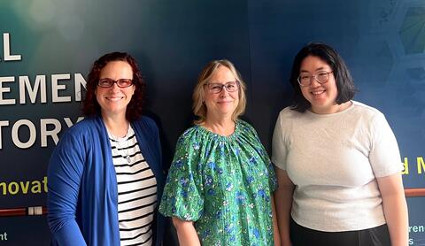 From left to right, Jessie Cahoon, Kim Stavish, and Megan Tran smiling for a group photo.