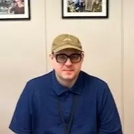 Sean Lehman sitting and posing for a headshot in a meeting room.