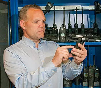 Dereck Orr with a variety of radios and cell phones