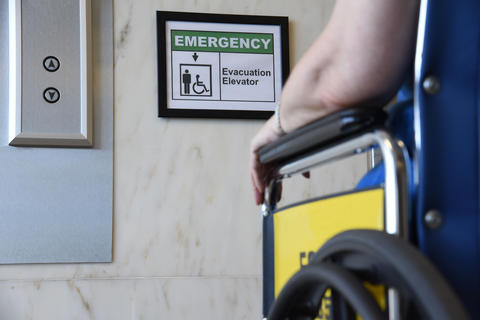 Image of a wheelchair in front of an elevator