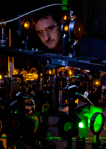 Researcher Kevin Wright checks part of the experimental apparatus.